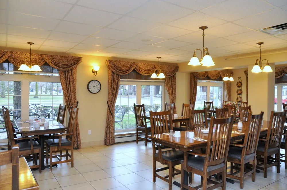 Parkview dining room with tall windows looking out toward Alexandra Park in Brantford