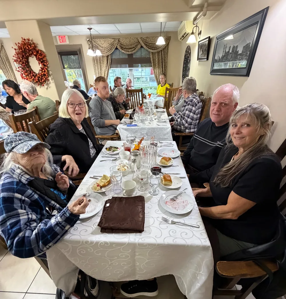 Residents and guests seated together at Thanksgiving dinner at Parkview